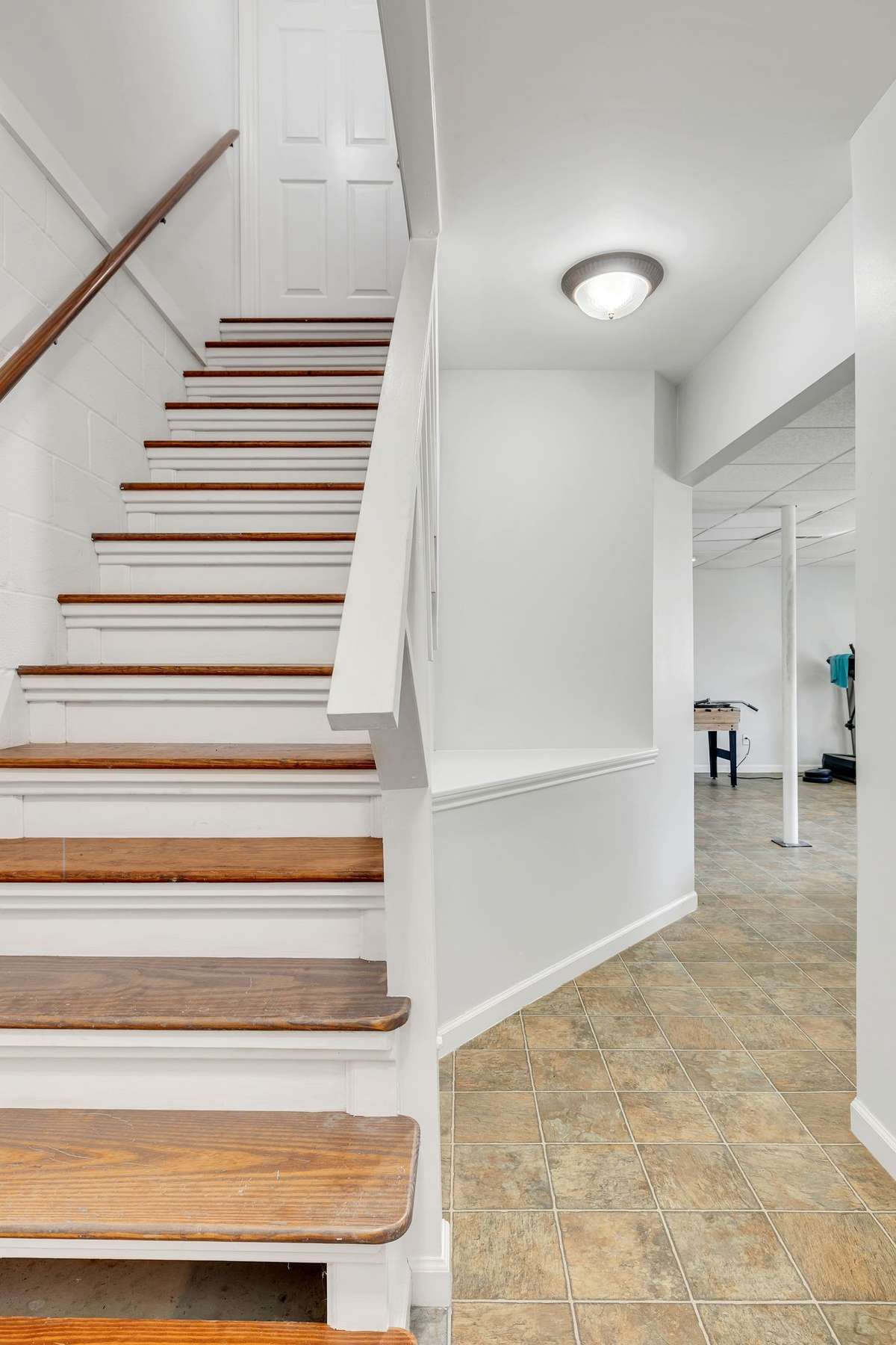 Staircase to the basement with wood tread staircase and fresh paint.