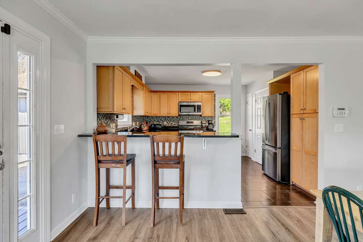 Dining opens to kitchen.  Home is very livable but is in need of updates including kitchen, baths, lighting etc.  Priced to allow a buyer to do those renovations and the homes in the support the investment.