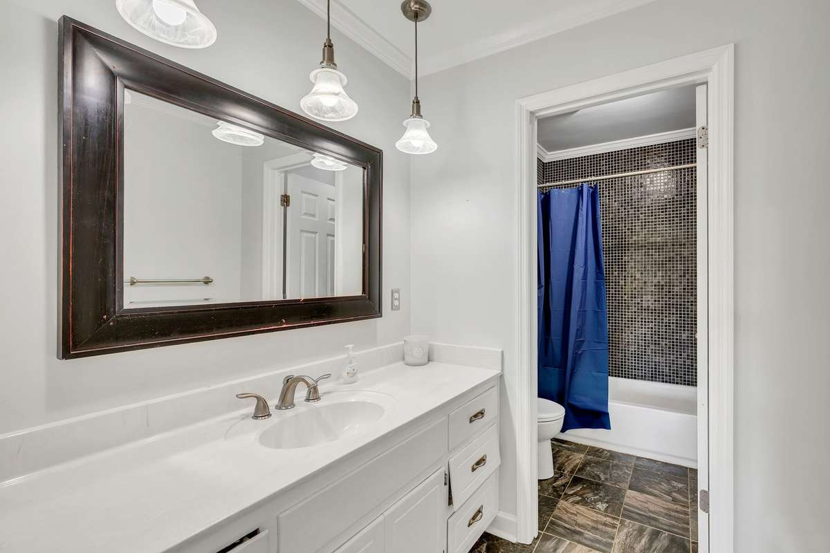Main floor bathroom serves both secondary bedrooms in the hallway.   Please note the PRIMARY BEDROOM IS LOCATED UPSTAIRS.