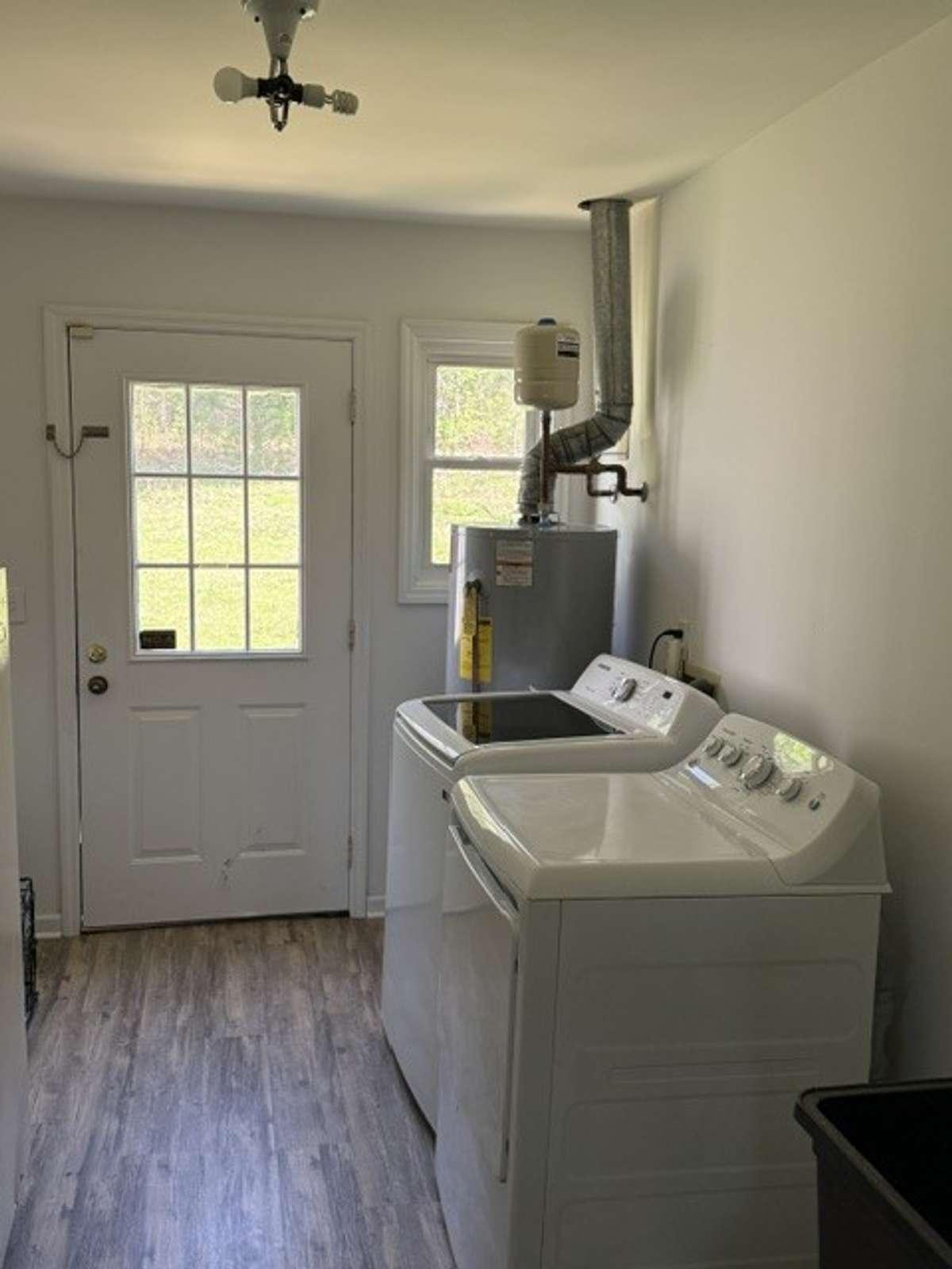 Oversized laundry room exits out the back door and it has a sink and the left wall not shown
in the photo has room for built ins and a freezer.