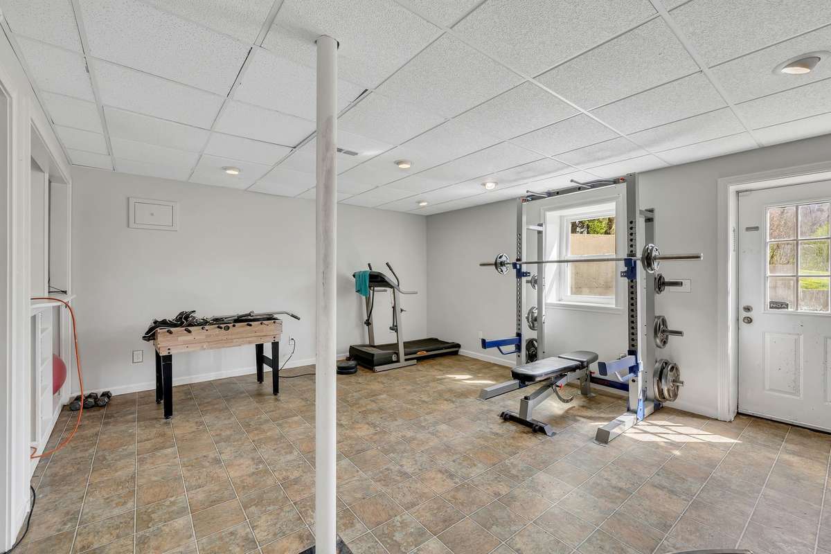 Huge room down can be an exercise room, a play room, office...etc.  Walk out door to the right side yard toward the barn.