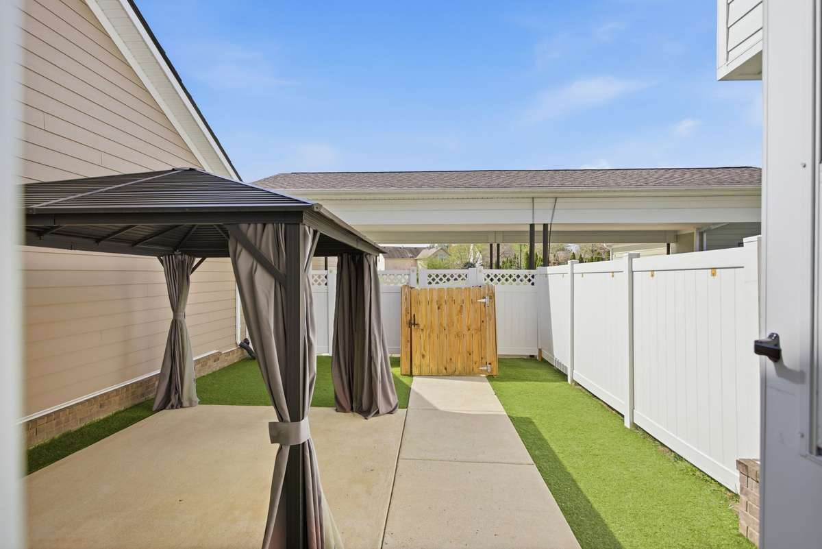 Private courtyard with covered patio and turf for convenience