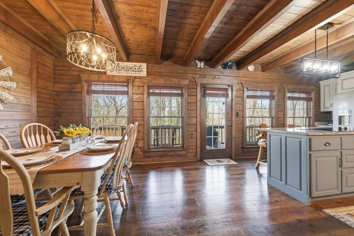 Dining-kitchen with door leading out to covered deck