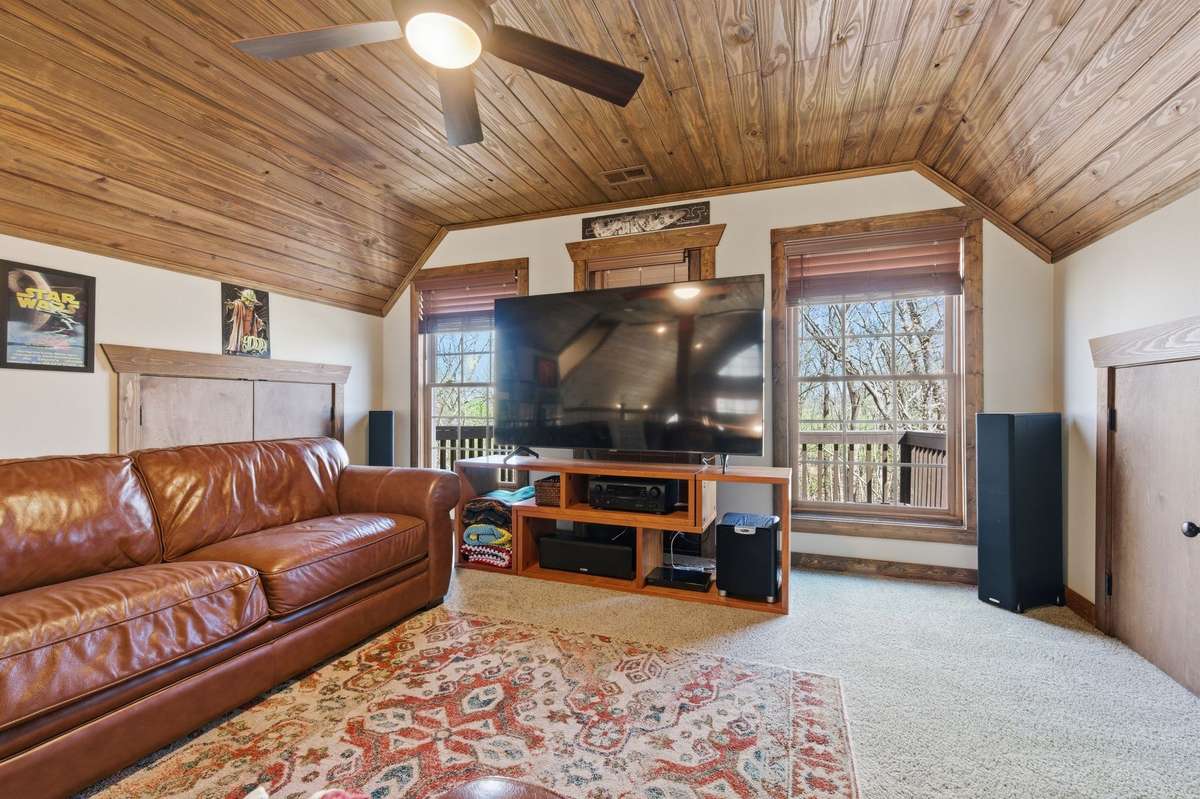 Media room-Door behind TV leading to balcony