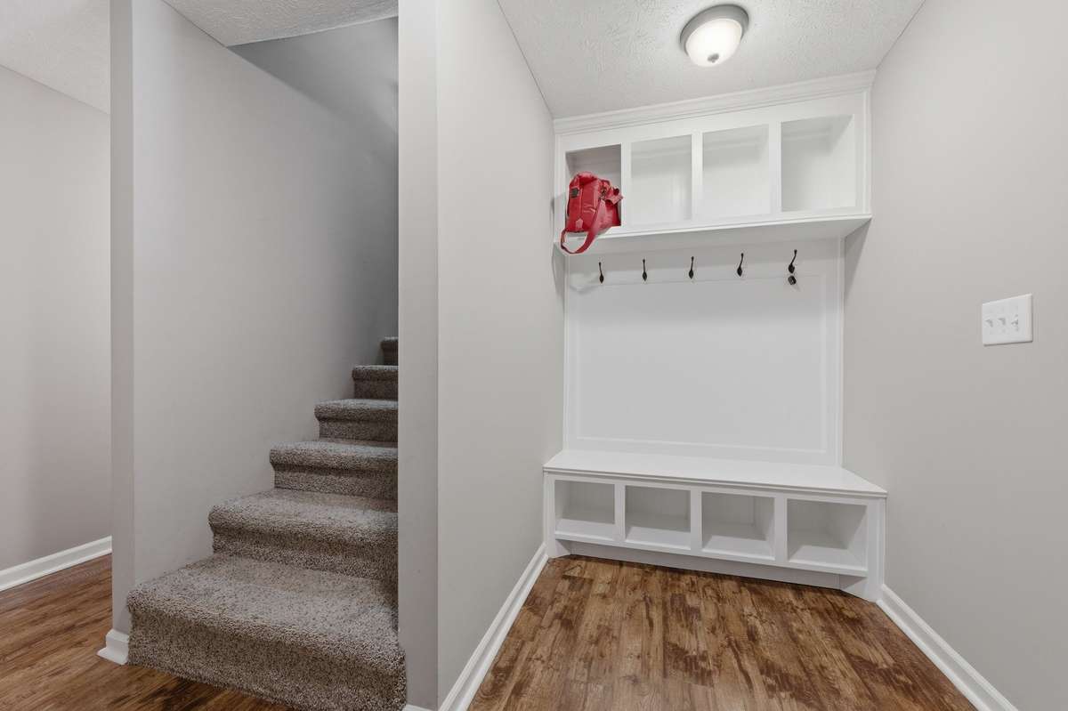 Stairs leading to finished basement-Mud room