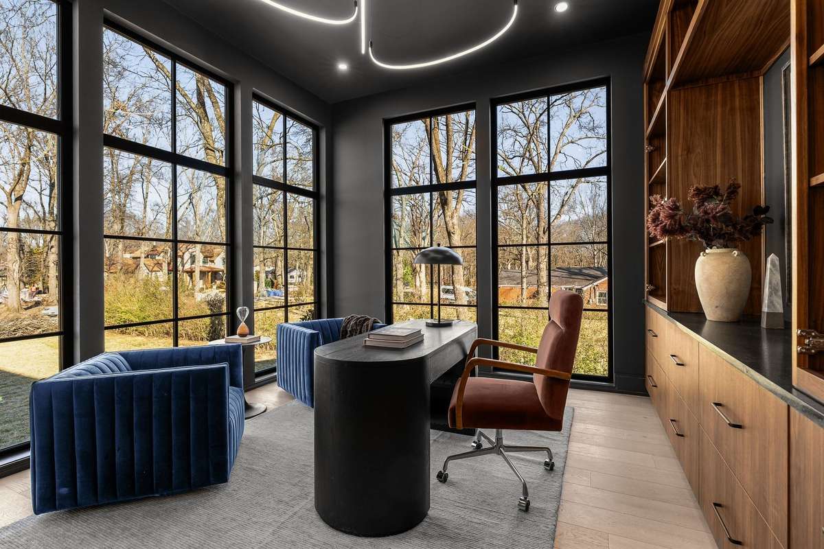 One of two home offices designed to inspire—wrapped in floor-to-ceiling windows, rich millwork, and views that make every workday feel elevated.