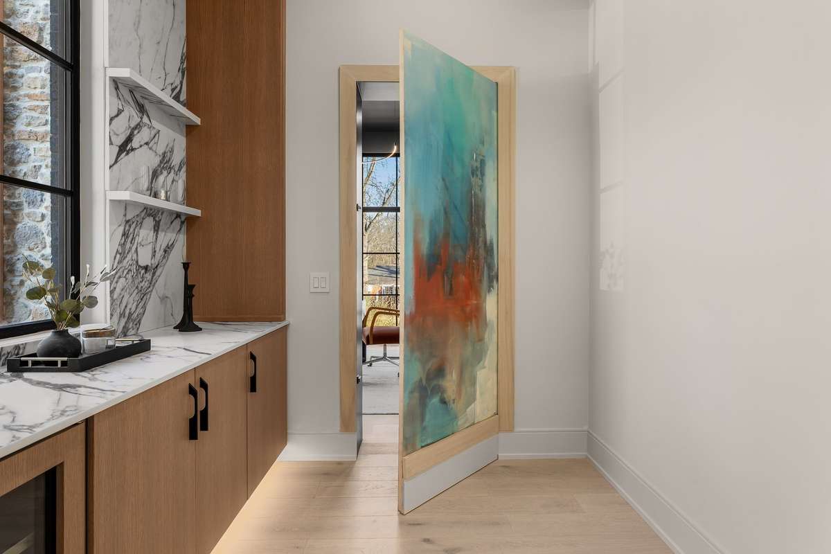 A striking concealed doorway, finished with original artwork by muralist MOBE, turns art into architecture—creating a functional entrance designed to surprise and captivate.