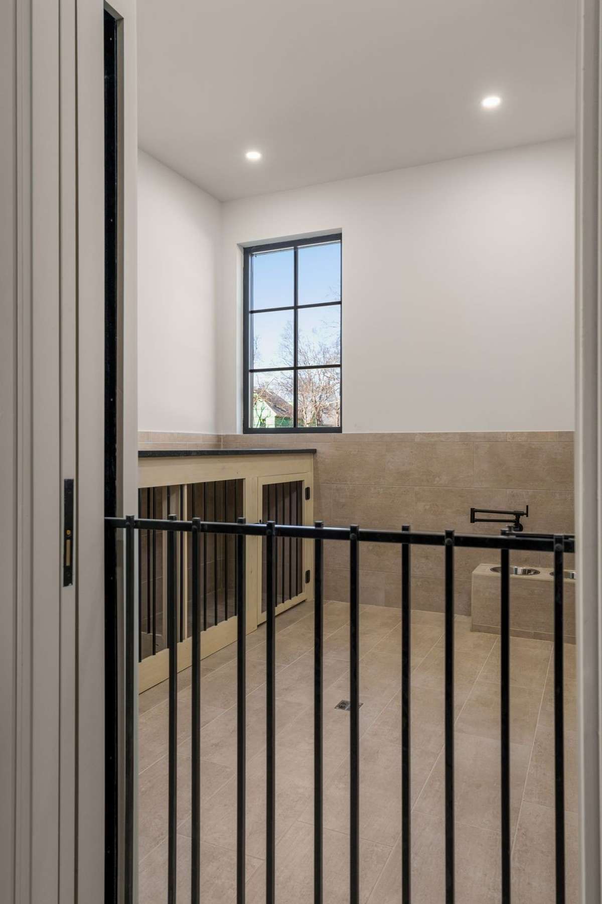 A custom gate keeps your furry companions safely contained while allowing them to remain part of everyday life.