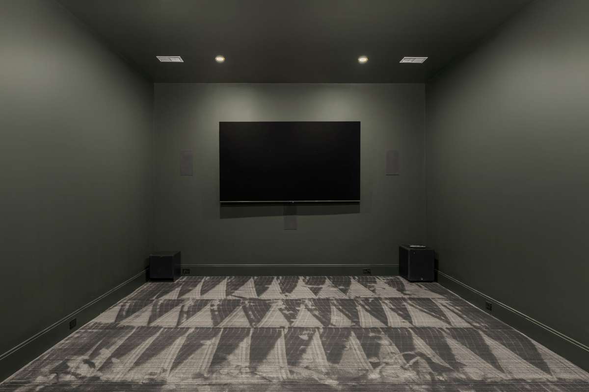 Private theater room designed for an immersive viewing experience with built-in speakers and a clean, modern aesthetic. Perfect for hosting movie nights.