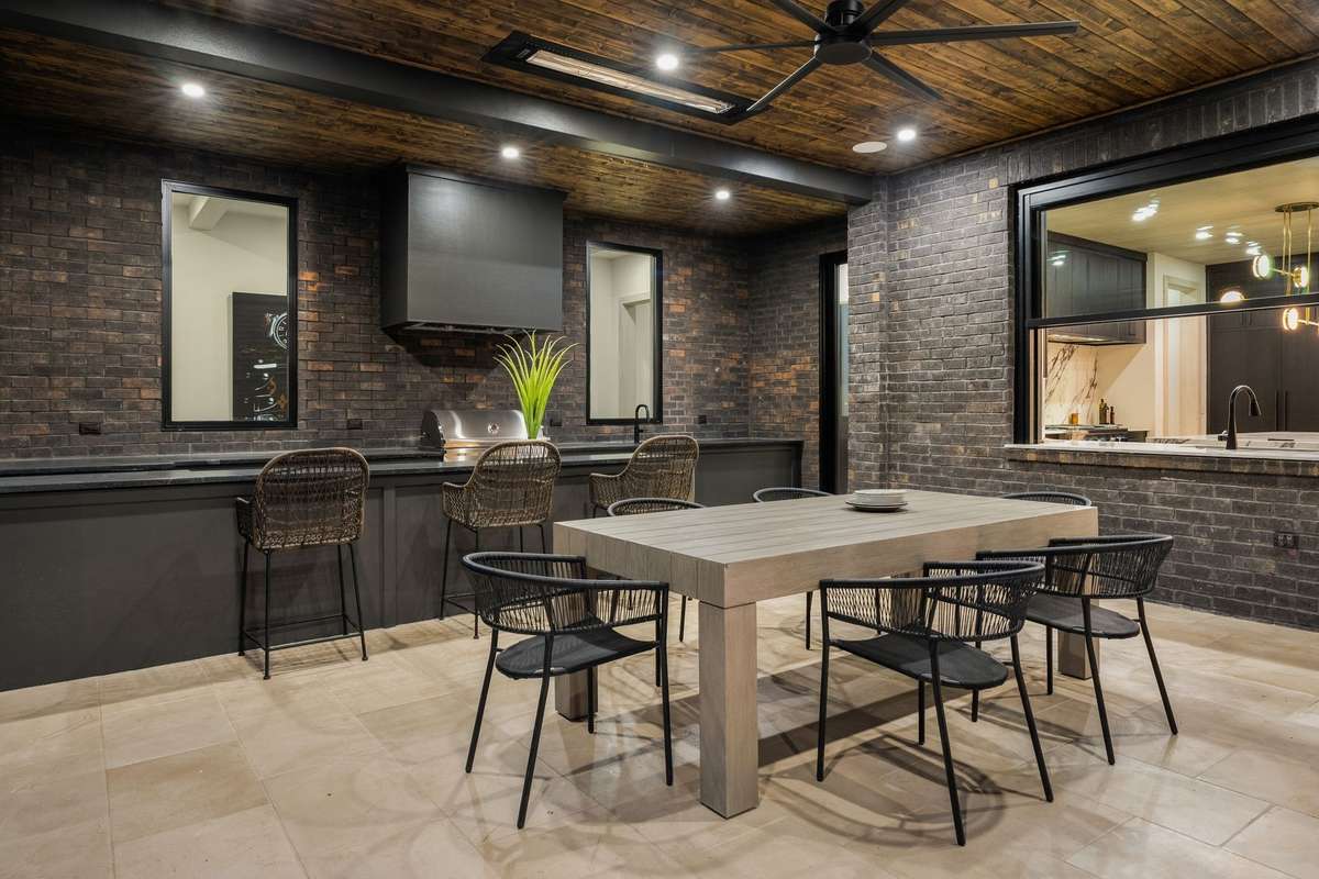 Fully equipped outdoor kitchen and dining area built for year-round hosting.