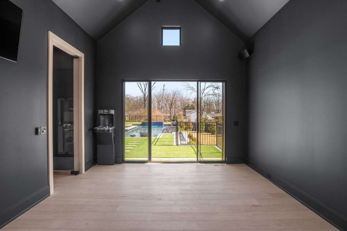 A dedicated fitness studio with a built-in water fountain, abundant light, and direct pool access—designed for training, recovery, and daily routine.