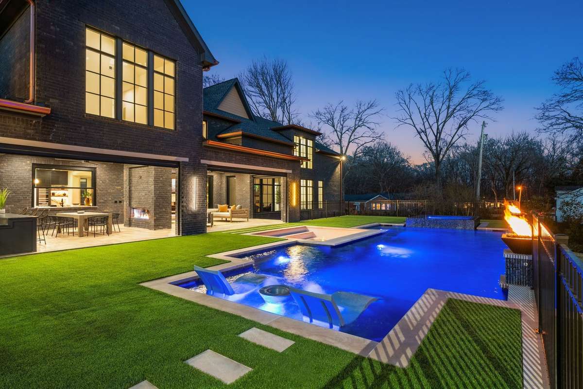 Backyard retreat featuring a thoughtfully designed pool, layered entertaining areas, and generous covered living spaces.