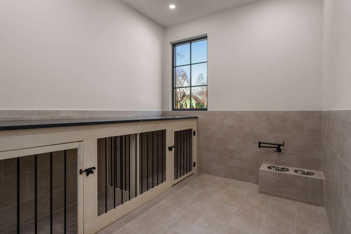 Even your four-legged family members have a luxury retreat—custom built-in kennels, elevated feeding/water station, a thoughtfully designed space that blends seamlessly with the home’s elevated aesthetic.