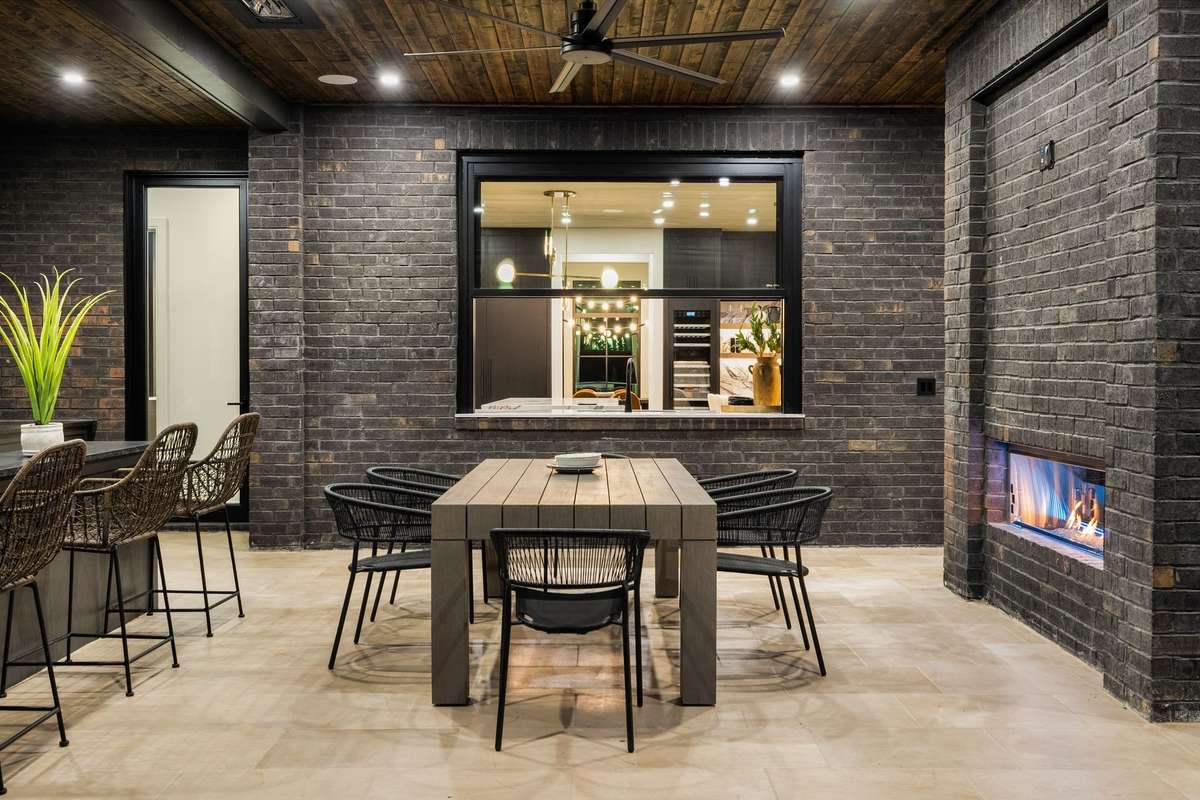 Covered dining area is conveniently located just outside the pass-through window, creating an effortless connection to the interior. Pass the burger buns please!