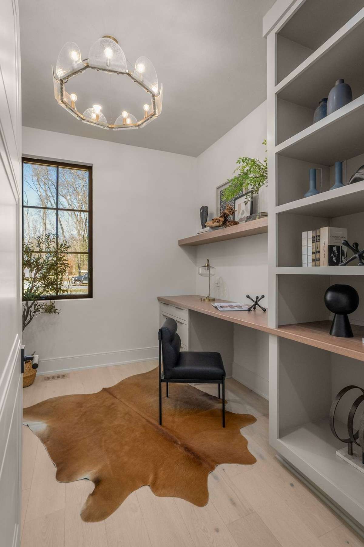 A second private workspace that proves productivity and style can coexist—custom built-ins, wall papered ceiling, and a quiet place to focus.