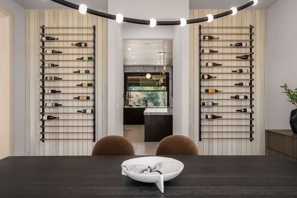 A custom wine display anchors the dining room, highlighting bottles that tell the story of celebrations past.