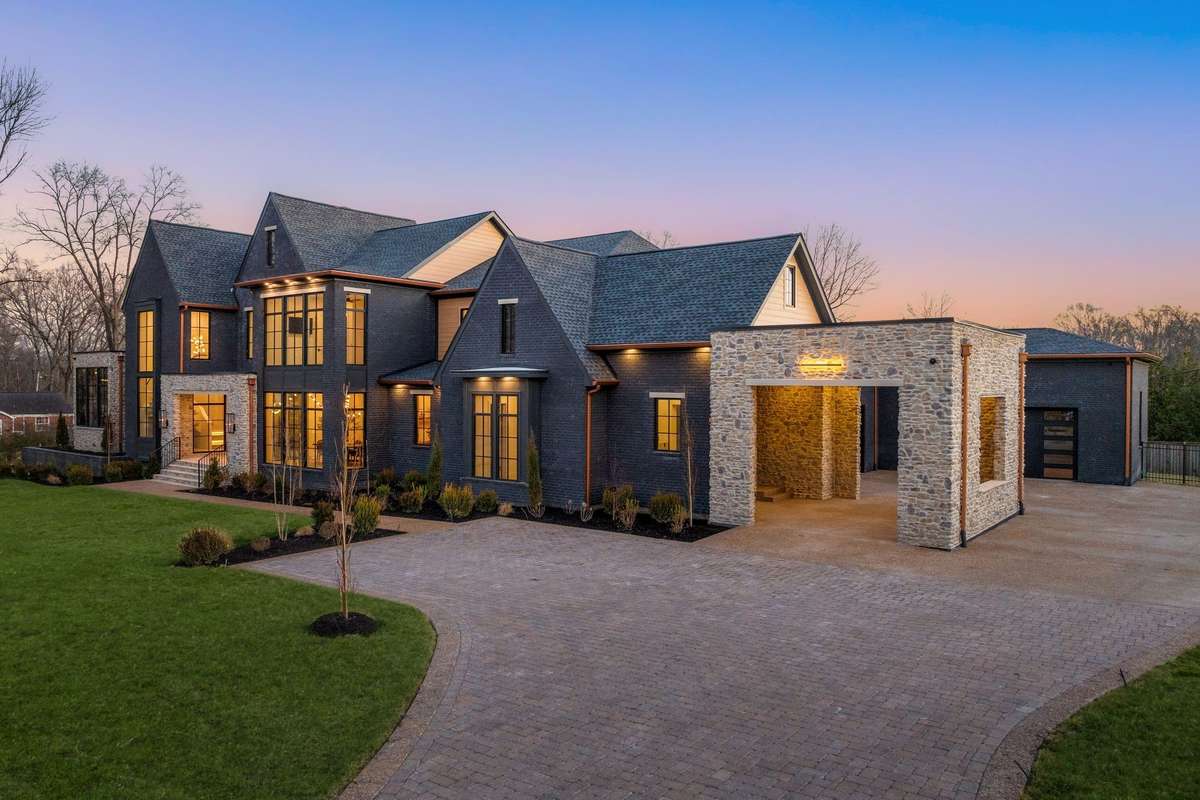 Arrive in style with a sweeping drive and stately porte-cochère—an elegant welcome that sets the tone before you ever step inside. Also functional, the side door leads you into the drop zone and dog suite.