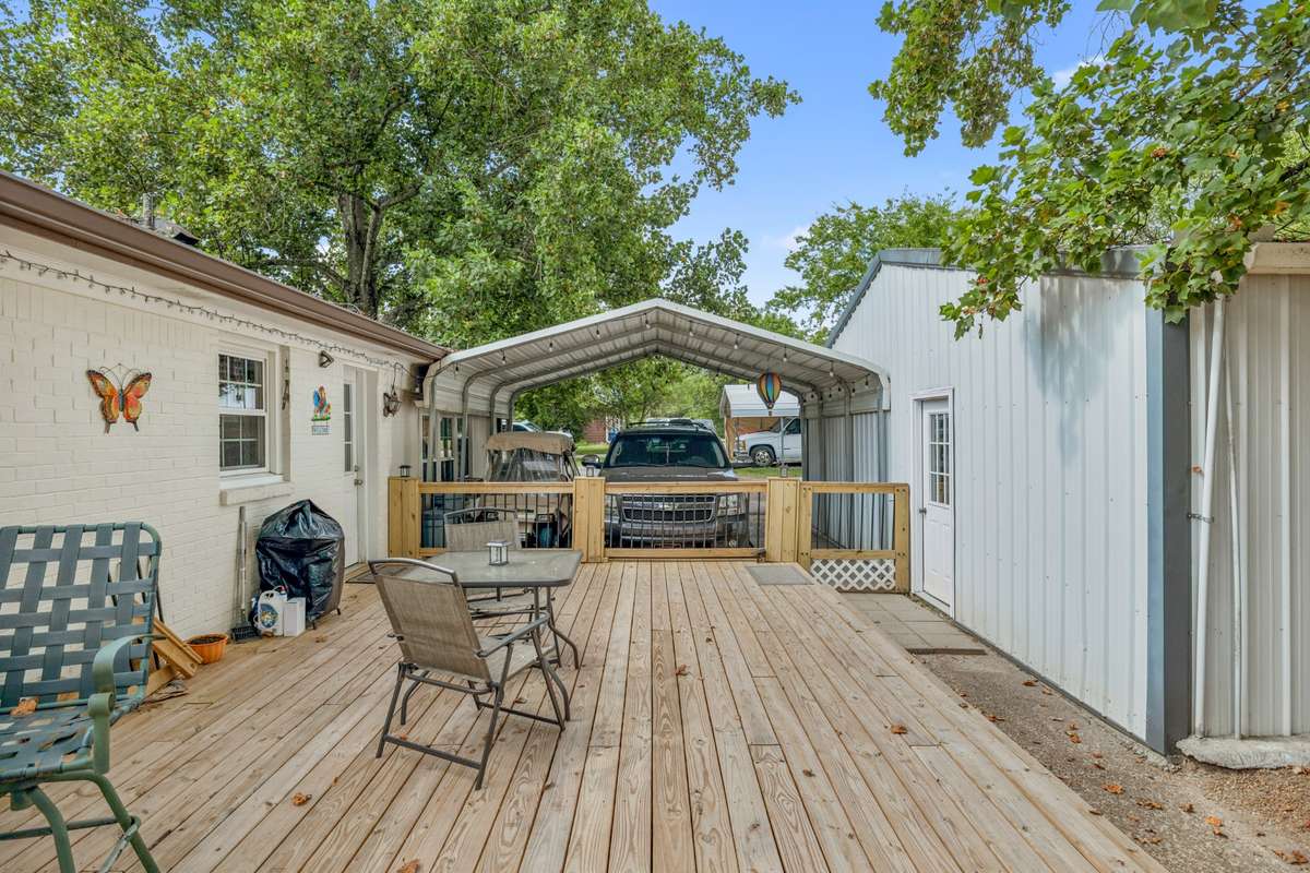 The back of the house leads to this large deck.  The building to the right is where the apartment/dwelling is.