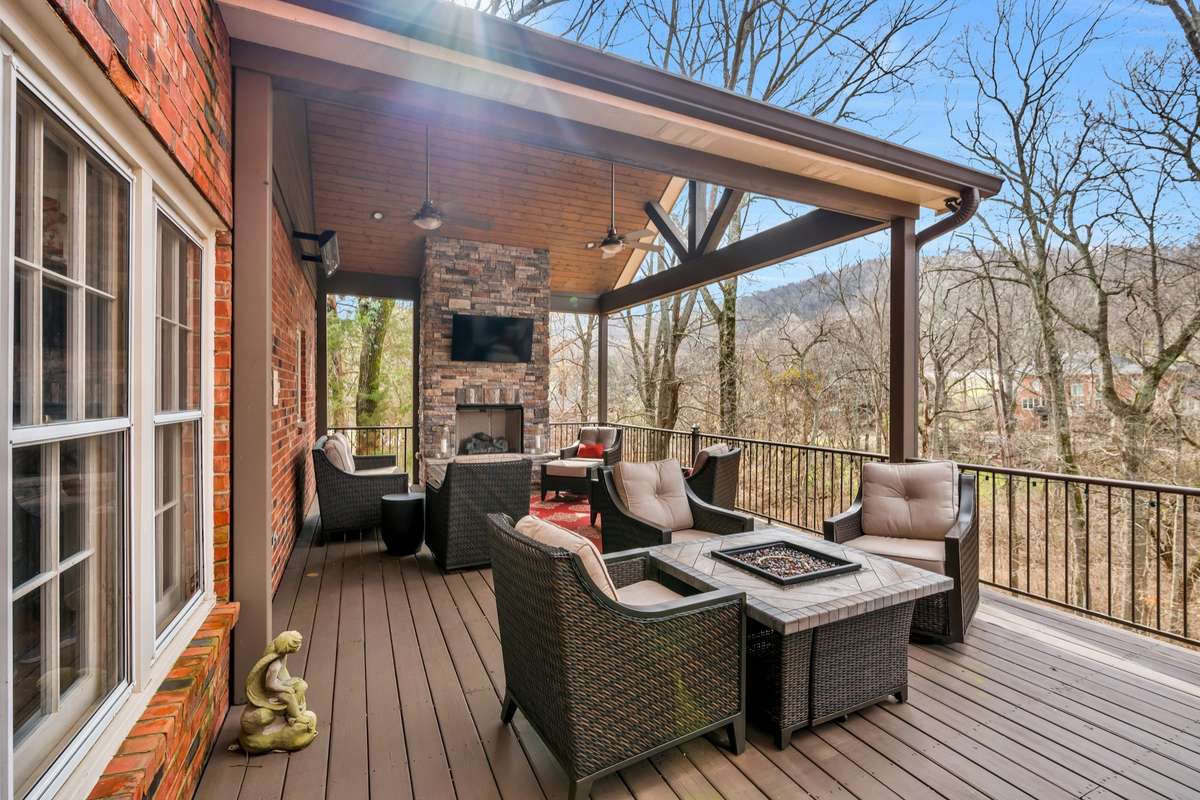 Covered deck with fireplace just off the kitchen