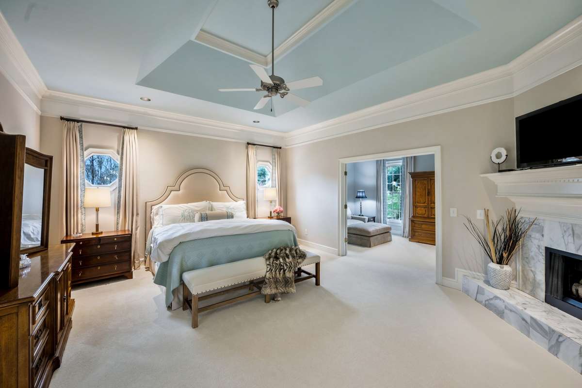 Renovated Primary Suite on main level with fireplace, adjoining study/office, beautiful window treatments to remain.
