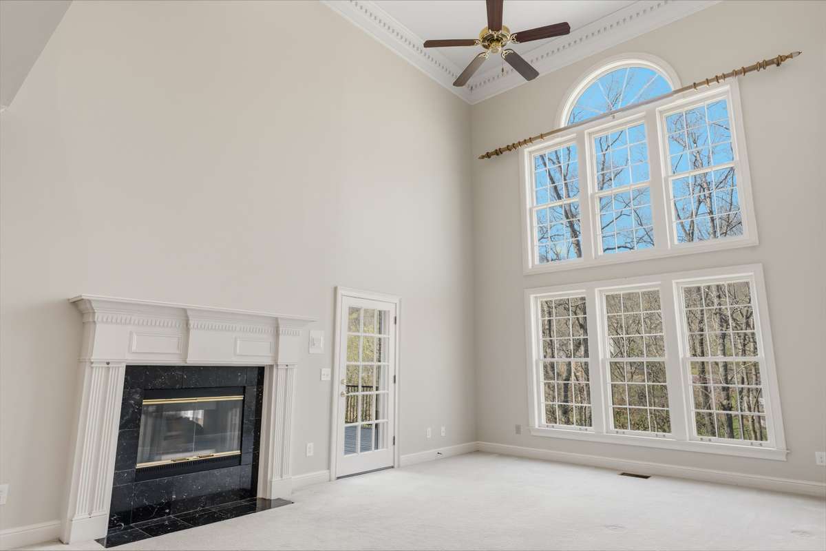 Light Filled Great room off the kitchen with fiplace and soaring ceilings.