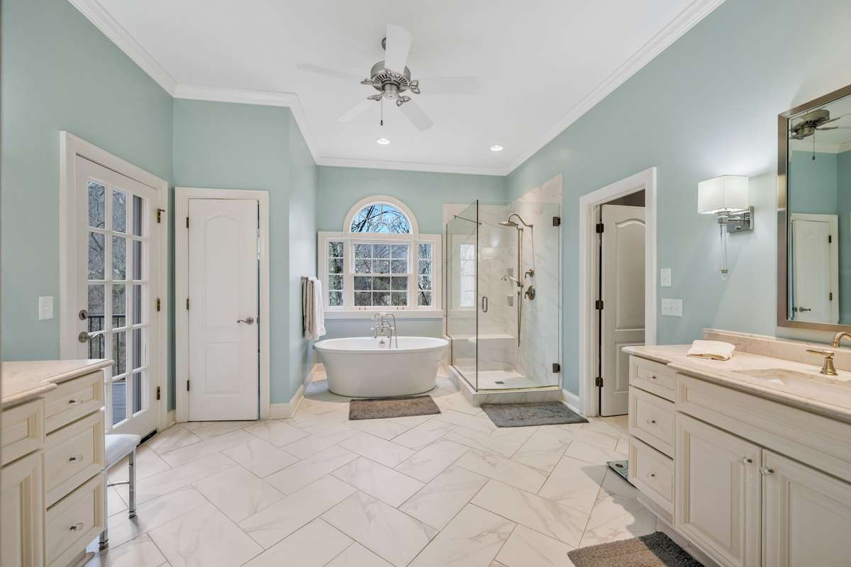 Renovated primary bath with double vanities, seperate shower tub and heated tile floors. This also opens to it's own private deck.