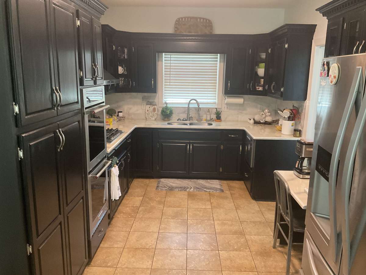 Newly painted cabinets and recently clear coated granite counter tops.