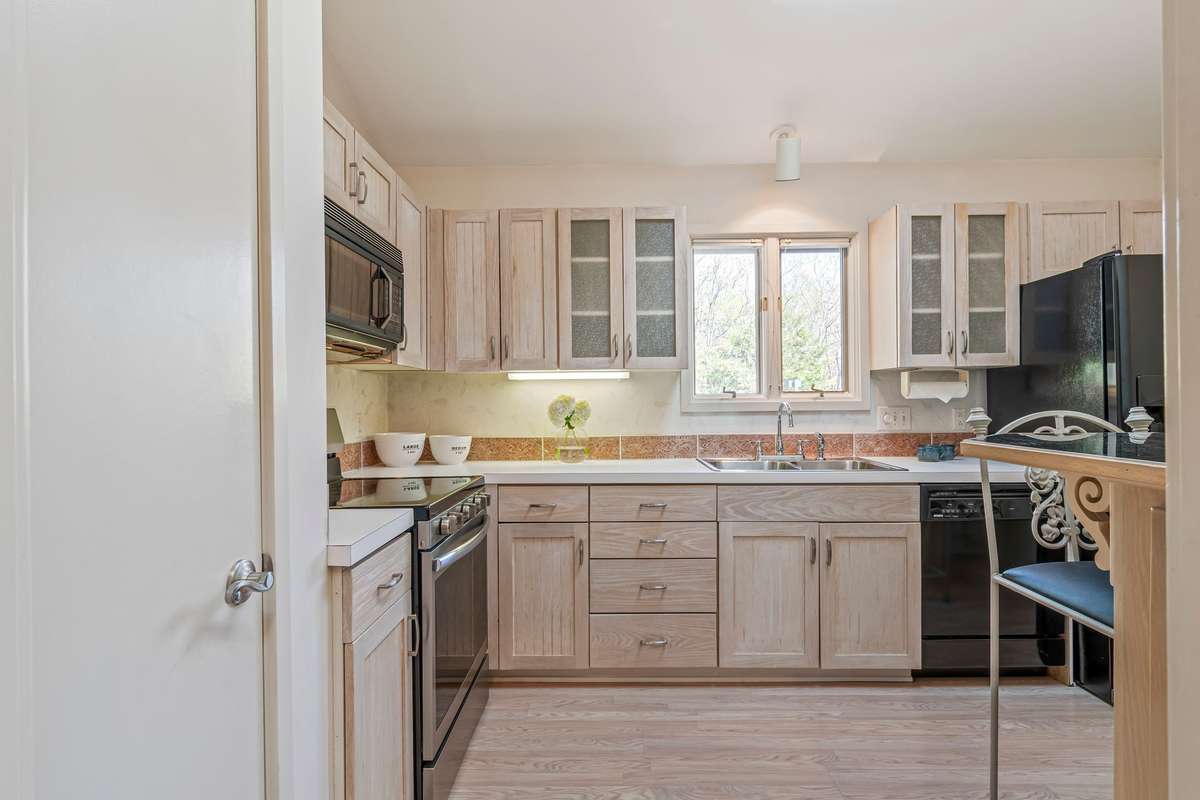 The kitchen has lovely light and ample cabinet space.