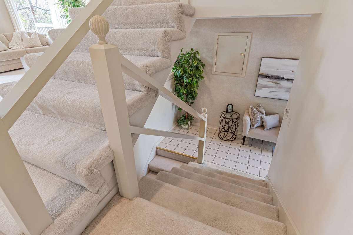 These stairs lead from the Foyer, up to the Living Room.