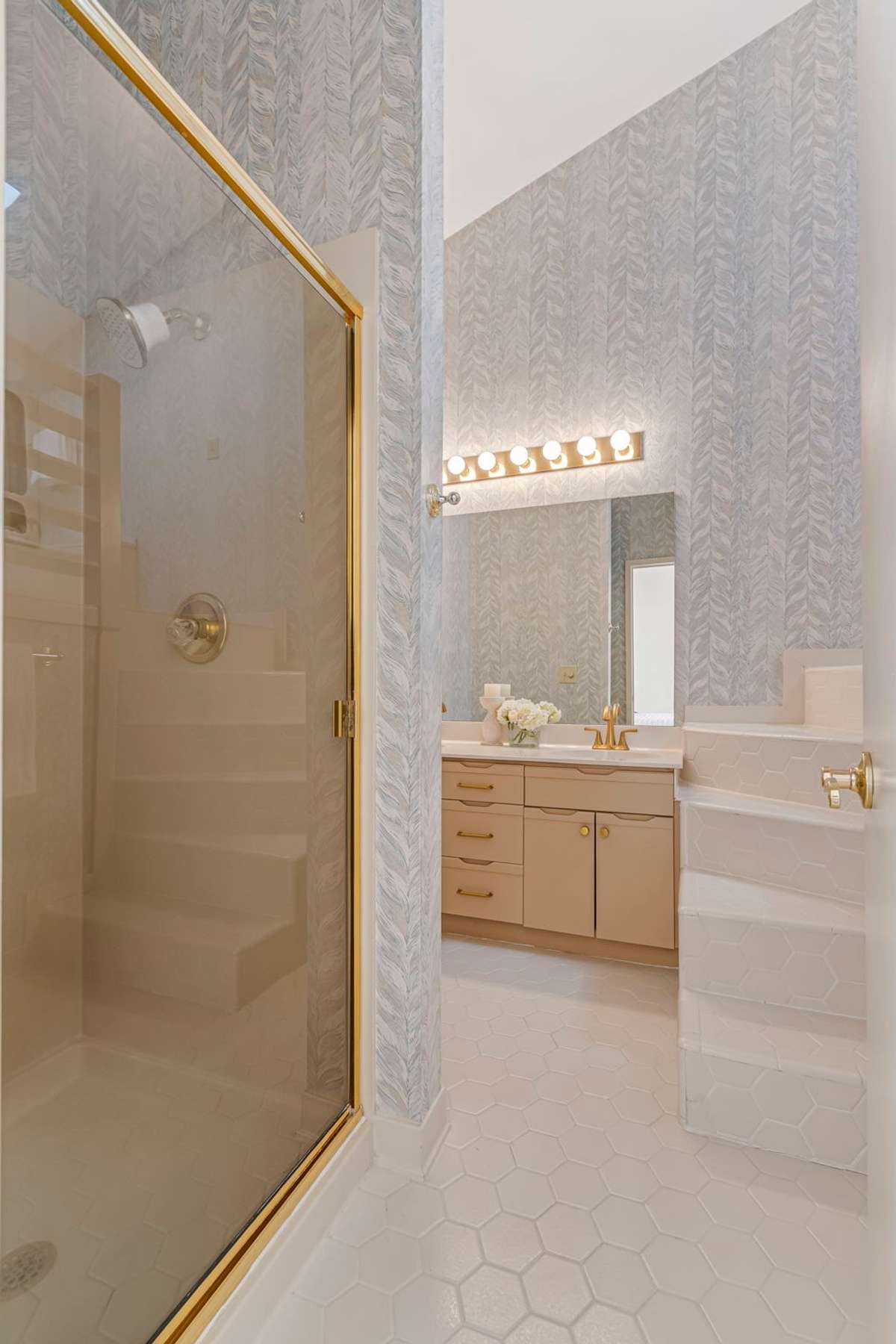 This bathroom features a shower, 2-sink vanity, toilet, and the stairs lead to a soaking tub. Imagine the possibilities here.