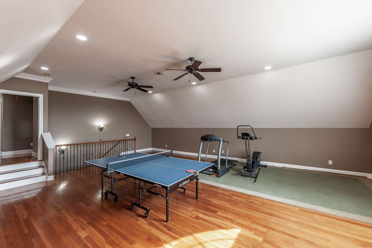 The bonus room above the garage is generously sized, offering plenty of space for entertainment seating, games, or a media area.