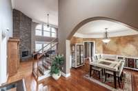 From the moment you enter, you are welcomed by a dramatic two-story great room anchored by a gas fireplace, creating an impressive yet inviting atmosphere.
