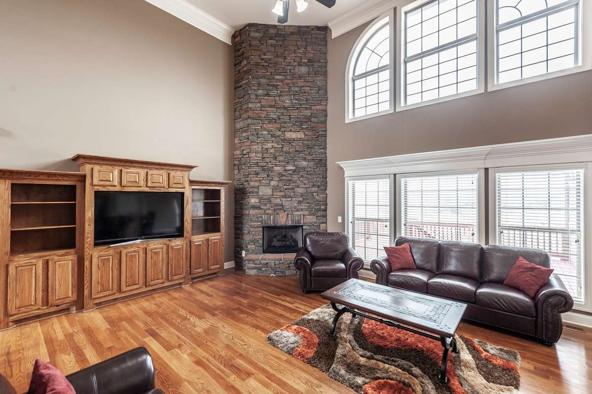 The beautiful stone fireplace anchors the room, adding warmth and character.