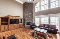 The beautiful stone fireplace anchors the room, adding warmth and character.