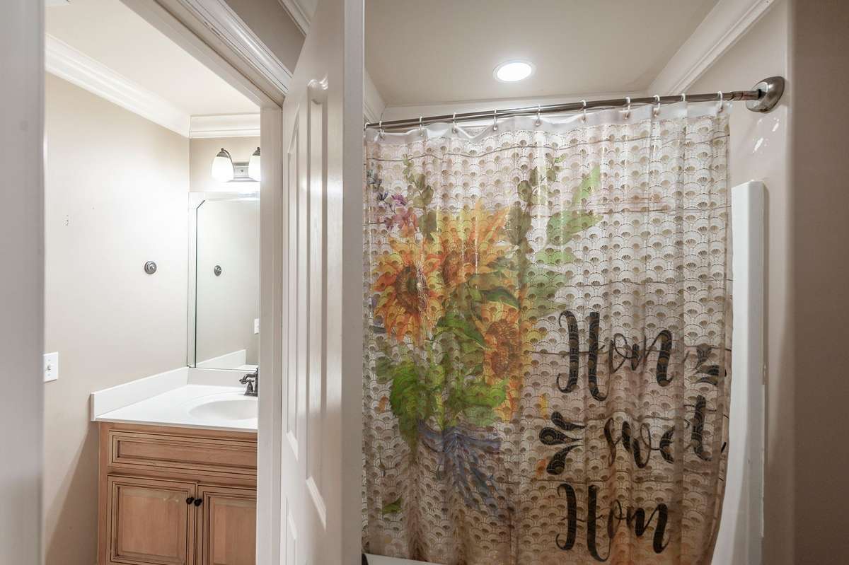 The hall bath adjoins the fourth bedroom.