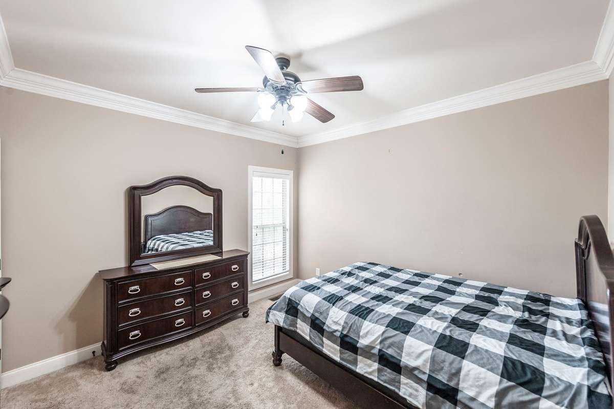The first-floor guest room is thoughtfully positioned on the opposite side of the home from the primary suite, providing excellent privacy for guests.
