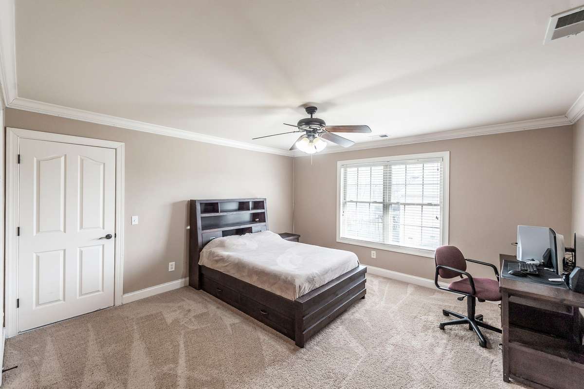 The fourth bedroom includes a full bath conveniently adjoining for added comfort.