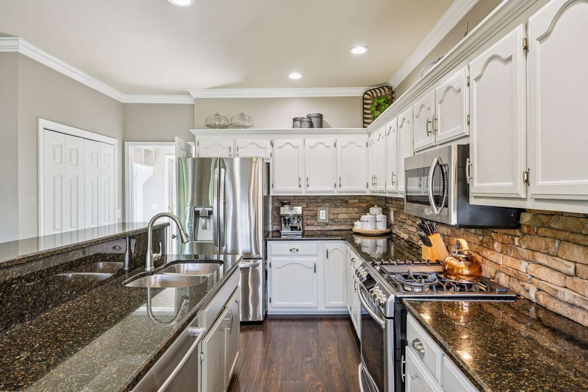 The Kitchen features and eat in Island with updated faucet and appliances. The gas stove with gas oven is a cooks dream.