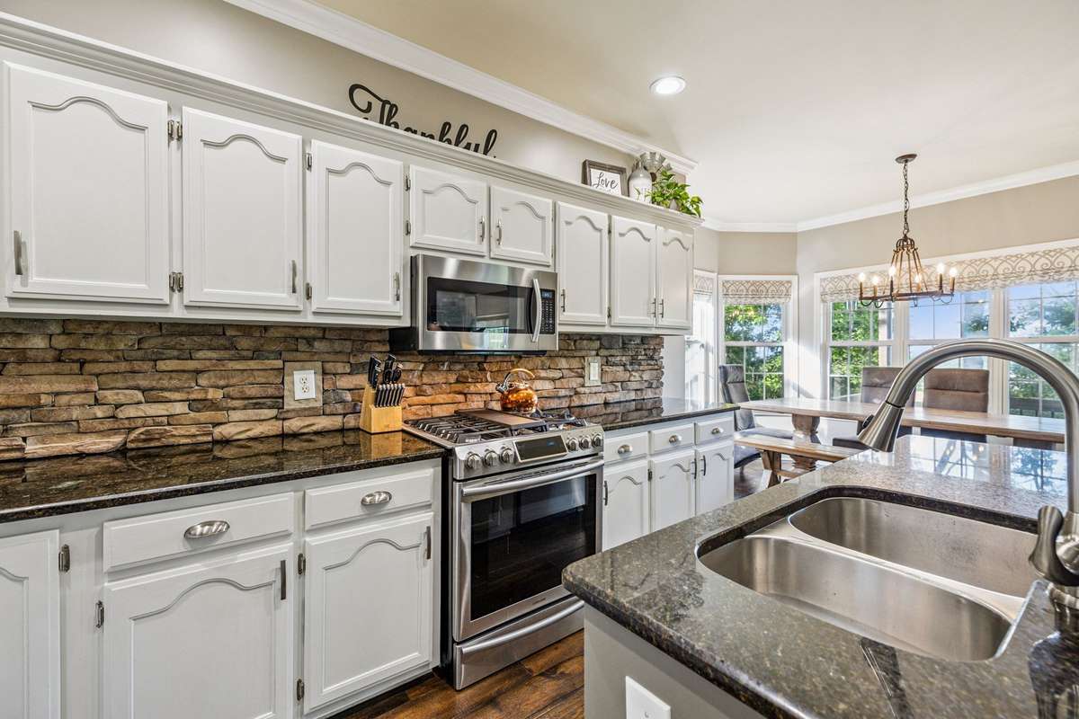 Stone backsplash matches the stone fireplace