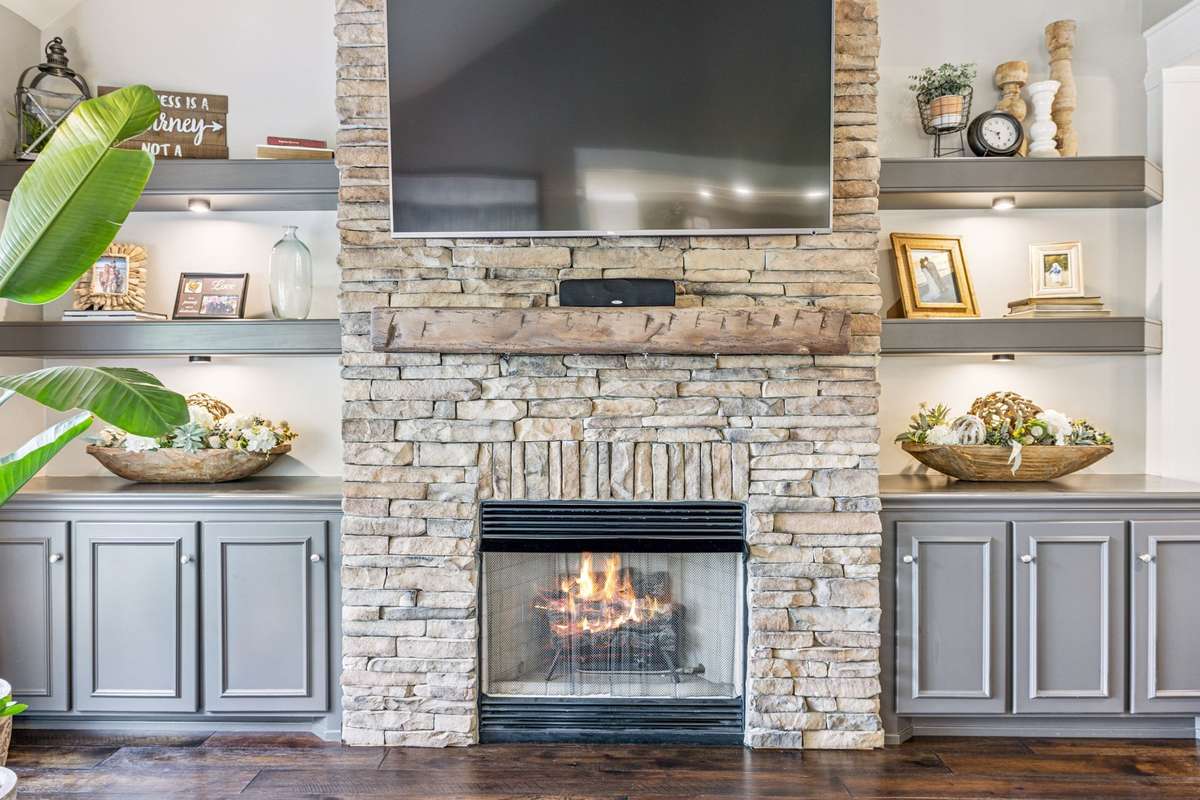 The stone fireplace was added by seller and is perfect for those cold winters