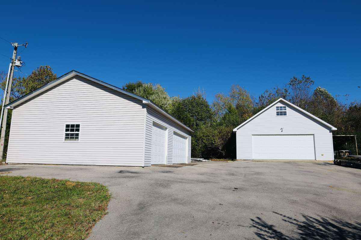 2 Detached garages one with a car lift and one with a room above the garage for storage.