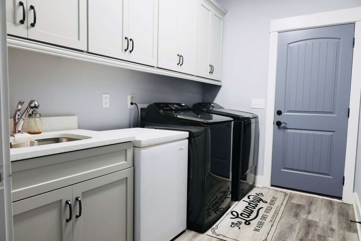 Laundry room with cabinets and sink. Freezer negotiable.