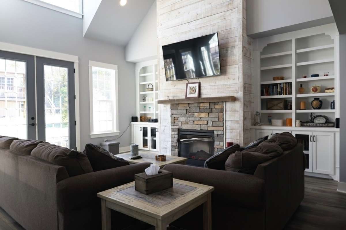 Great room with built in book shelves and electric fireplace.