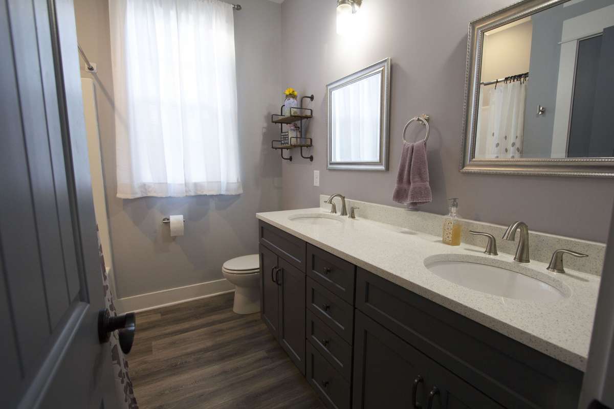 Hall Bath with double sinks and Quartz countertops.