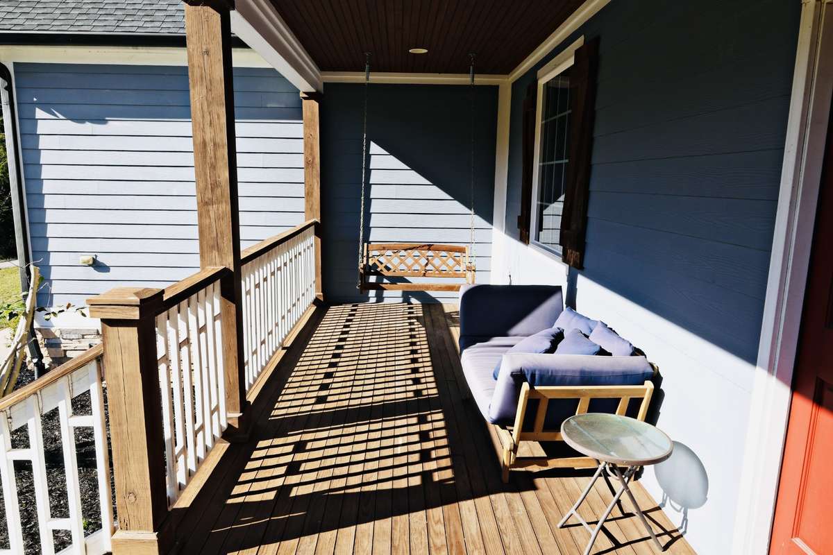 Front porch with wooden swing.