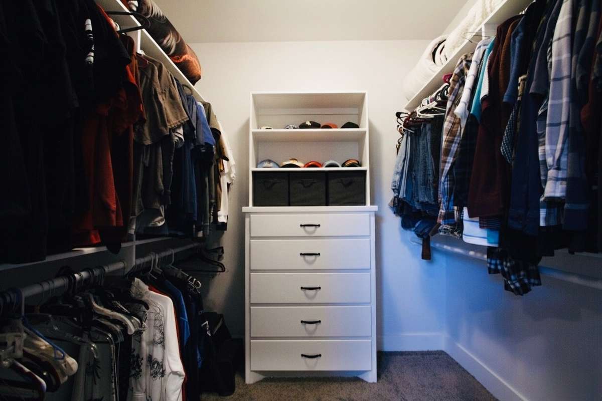 Primary closet with built in dresser.