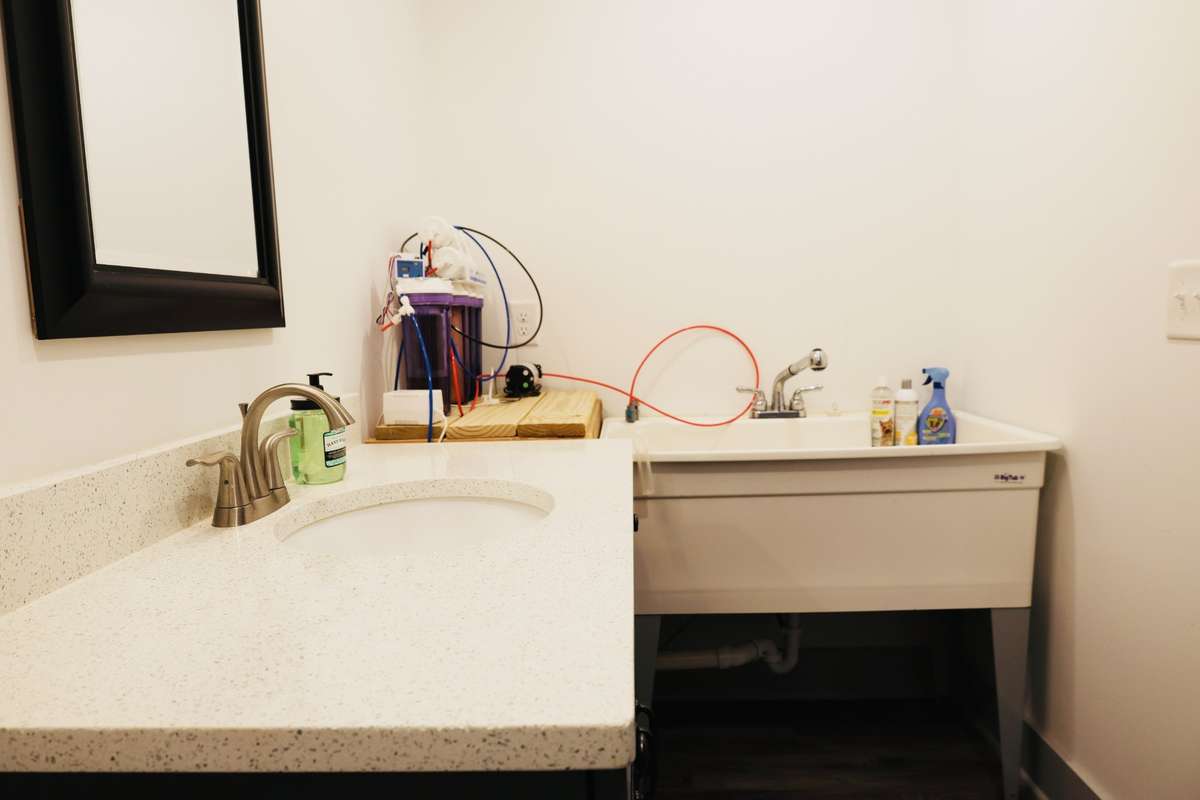 Upstairs bathroom with Quartz countertops and Dog washing station.