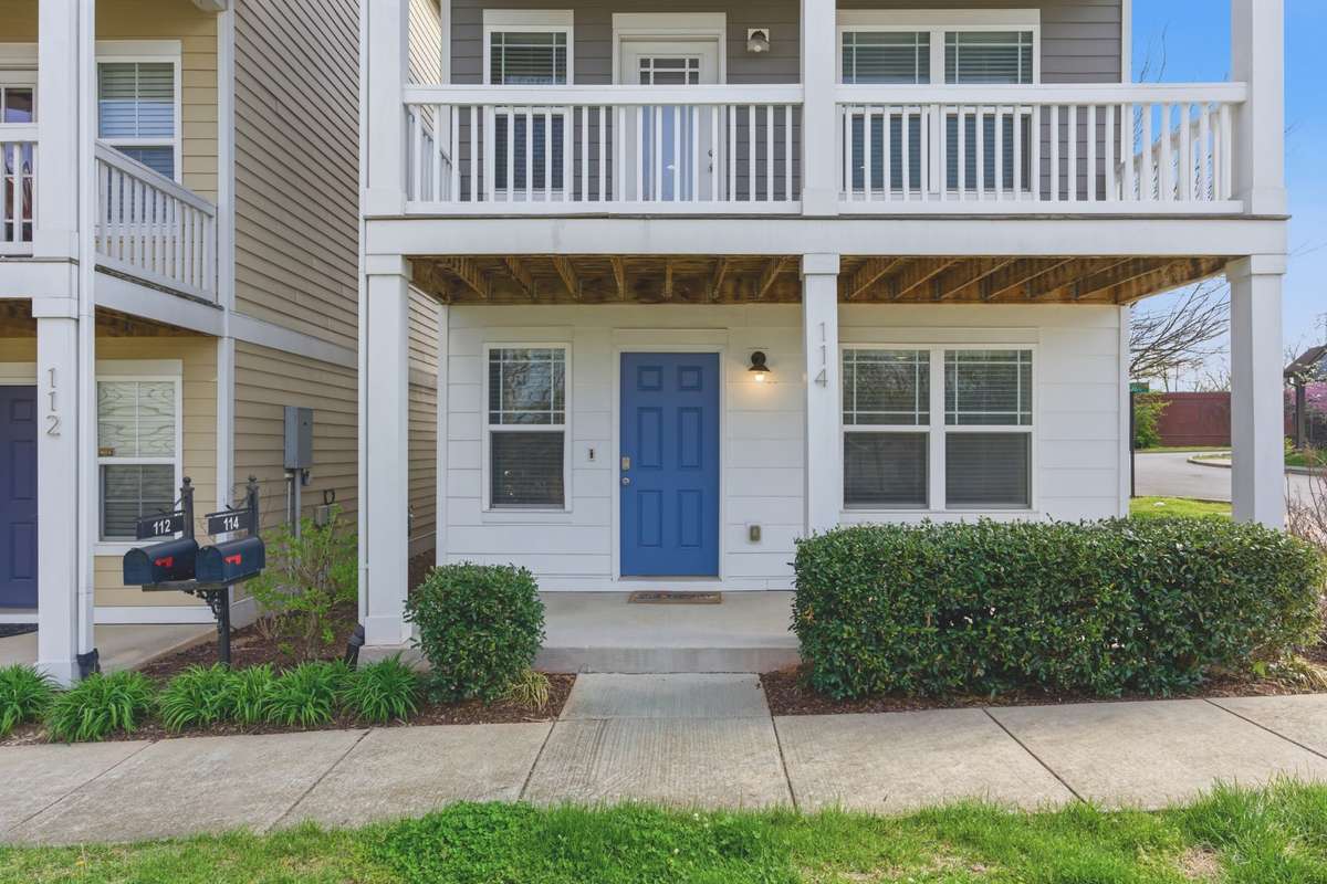 Private, covered front porch with direct entry and landscaped walkway.