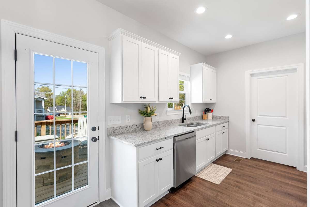 Glass door to the right between dining room and kitchen leading to the back deck.