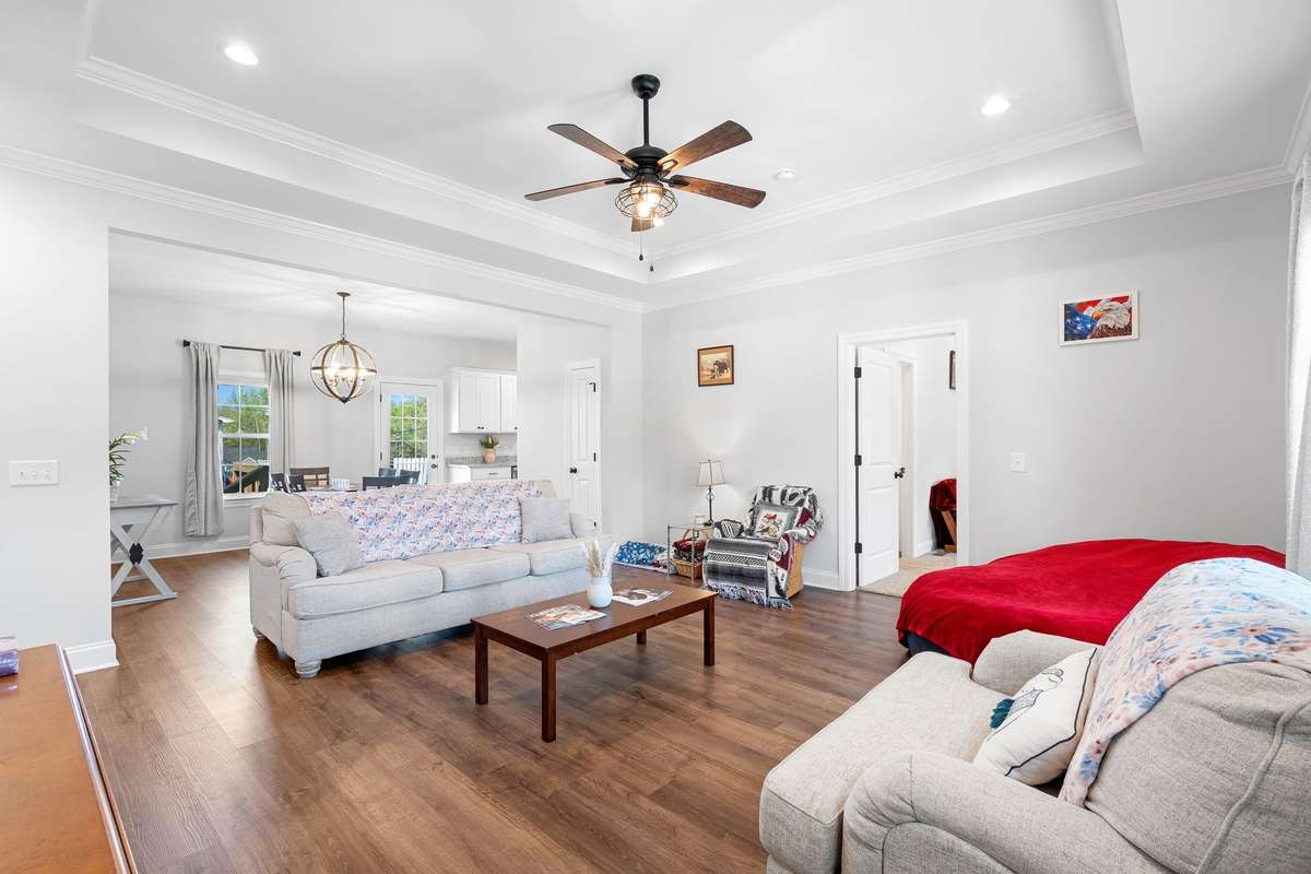 Open concept living space featuring 10 ft ceilings, trey ceiling, and natural light.